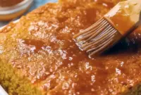 Slice of golden Sweet Potato Cornbread on a wooden board, glazed and ready — a top Quick Potato Side Dishes pick for cozy dinners.