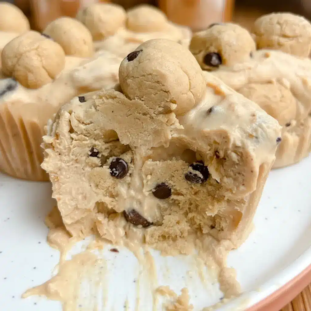 Close-up of three Cookie Dough Cups in paper liners: creamy yogurt base, little protein cookie-dough bites, and chocolate chips on top.
