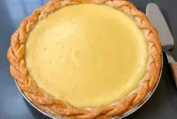 Apple Custard Pie slice on a white plate, glossy custard and browned single crust visible — a close-up of a classic Single Crust Pie (Marlborough Pie).