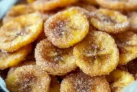 Golden, cinnamon-dusted Air Fryer Banana Chips piled on parchment, crisp and ready to eat — a tasty Healthy Snacks Teenagers will reach for.