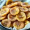Golden, cinnamon-dusted Air Fryer Banana Chips piled on parchment, crisp and ready to eat — a tasty Healthy Snacks Teenagers will reach for.