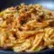 Close-up of glossy Caramelized Onion Pasta tossed with jammy onions, chili oil sheen, and grated Parmesan — a rustic Pasta Dishes favorite.