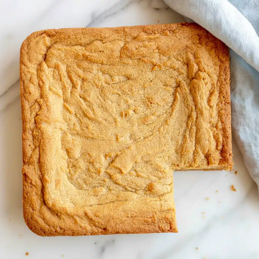 Close-up of a warm, crackly-topped Peanut Butter Brownies square with a melting scoop of vanilla ice cream beside it.