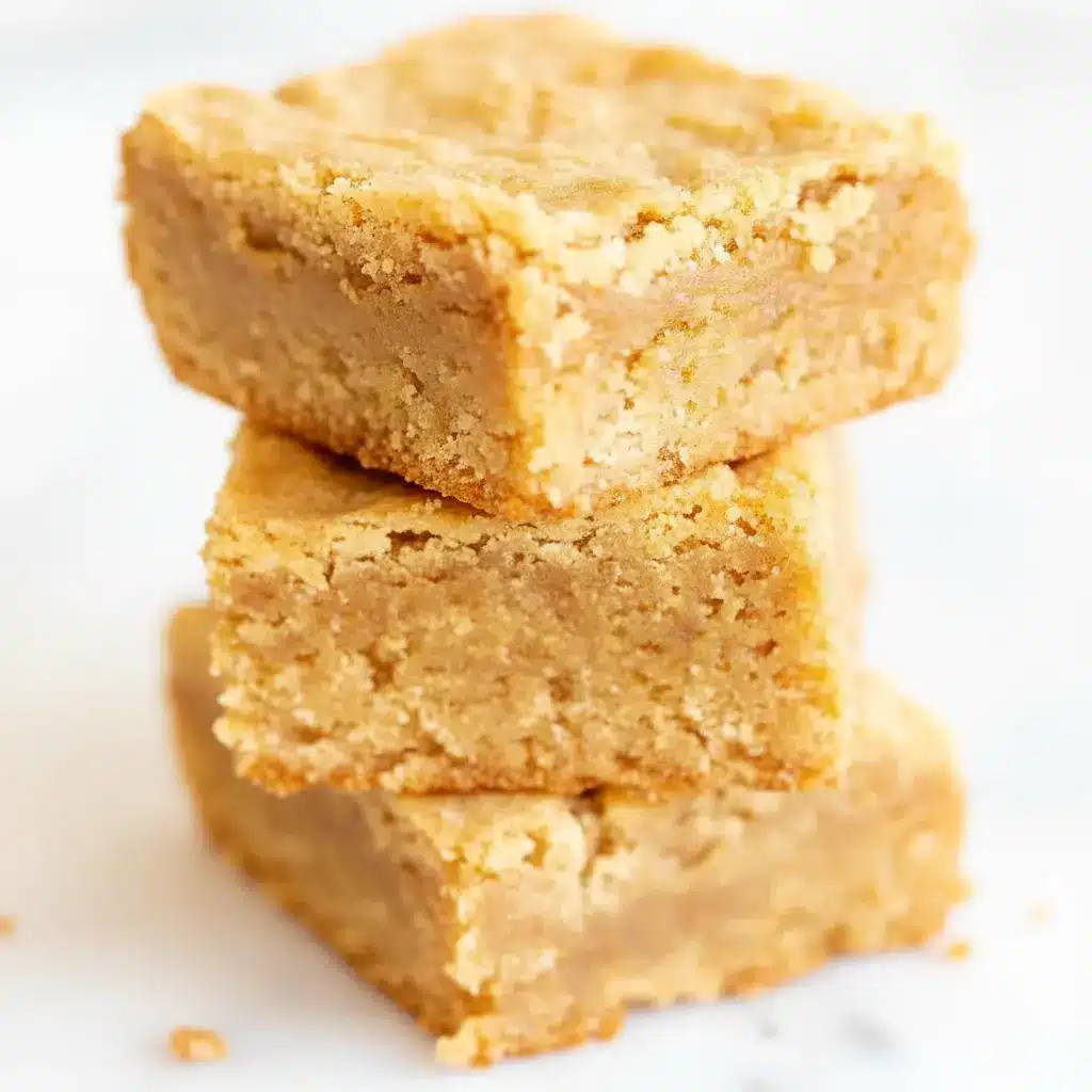Close-up of a warm, crackly-topped Peanut Butter Brownies square with a melting scoop of vanilla ice cream beside it.
