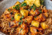 Pineapple Chicken and Rice served in a cozy bowl with Dinner With Pineapple flavors, golden chicken, and glossy sauce over fluffy rice.