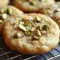 A close-up tray of Salted Honey Pistachio Cookies with flaky salt and chopped nuts, styled as irresistible Pistachio Flavored Cookies for dessert lovers.