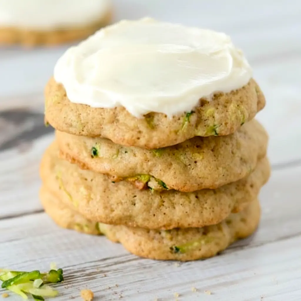 A plate of Zucchini Cookies topped with creamy frosting, styled as a soft homemade dessert inspired by Zucchini Cookies With Cream Cheese Frosting and Zucchini Recipes Cookies.