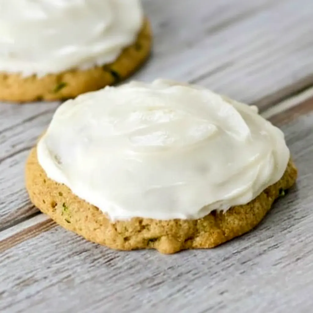 A plate of Zucchini Cookies topped with creamy frosting, styled as a soft homemade dessert inspired by Zucchini Cookies With Cream Cheese Frosting and Zucchini Recipes Cookies.