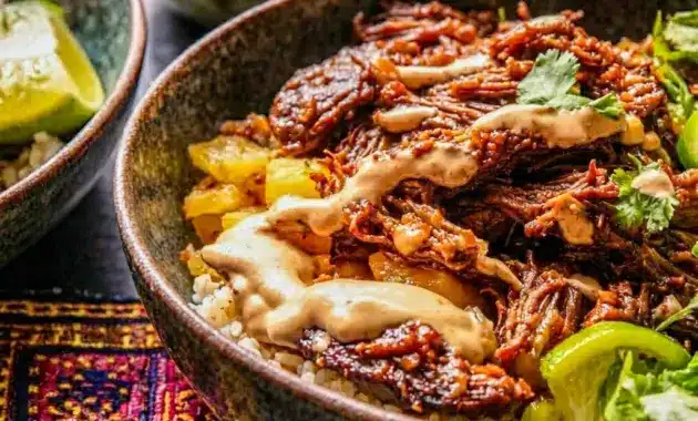 Crockpot Chipotle Pineapple Pot Roast Bowl with tender shredded beef, a sweet and smoky Pineapple Pot Roast flavor, and a rice base.
