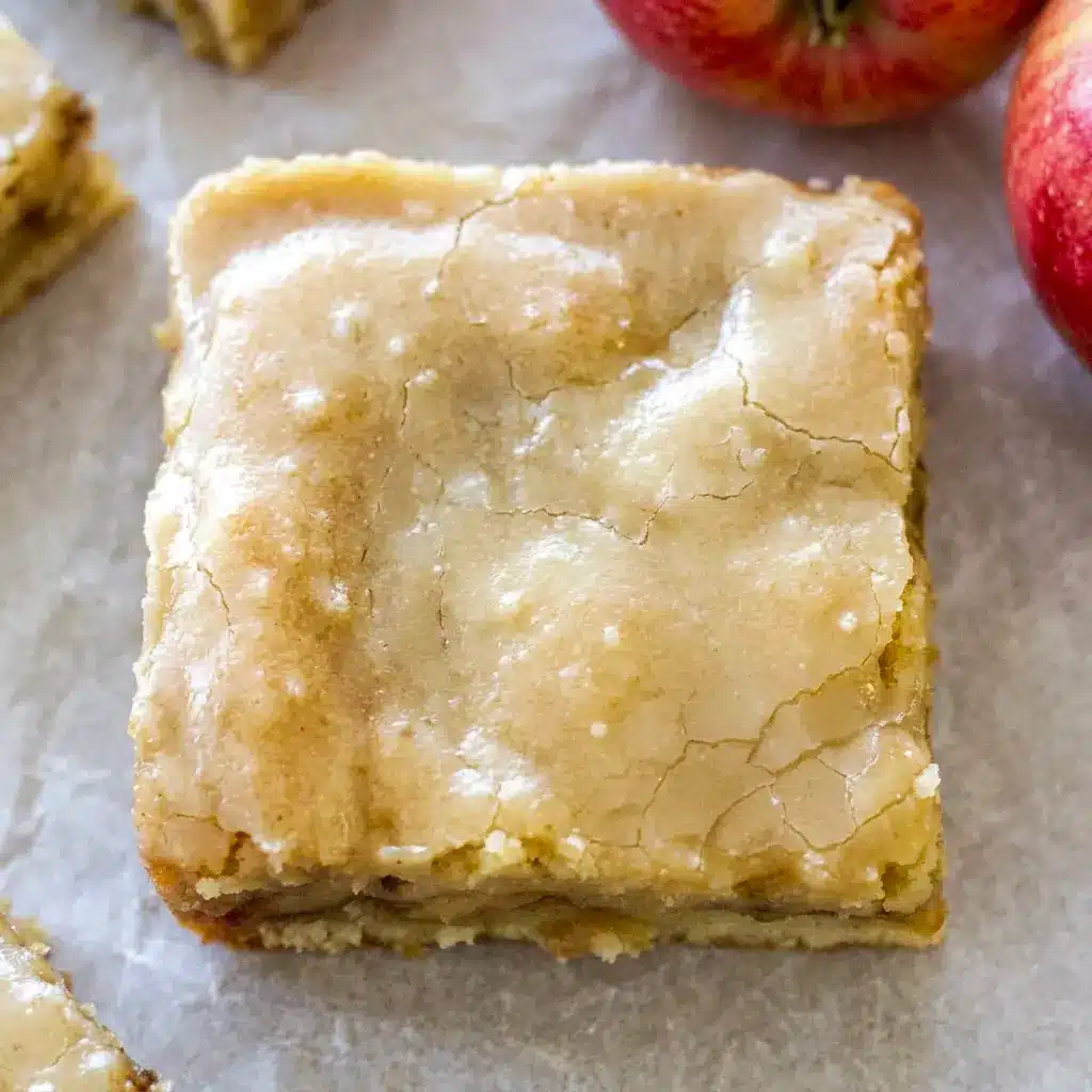 Fresh-baked Maple Glazed Apple Blondies with a thick maple finish and cinnamon spice, inspired by Apple Cinnamon Blondies With Maple.