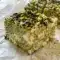 Pistachio and White Chocolate Rice Krispies Treats are styled as Pistachio Topped Treats with chopped nuts and a rich chocolate drizzle.