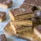 Salt River Bars stacked on a dessert tray for a rich Salt River Bars Recipe with caramel, chocolate, and flaky sea salt.