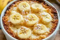 A warm pan of Southern Banana Cobbler served bubbling and golden, styled as a cozy Banana Cobbler Recipe for family dessert night.