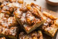 Cinnamon Roll Focaccia on a tray with a golden glaze, styled as one of the best Homemade Baked Snacks for brunch.