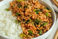 Firecracker Ground Chicken Bowl for Light Family Dinners, served in a colorful skillet with broccoli and a sweet-spicy sauce.