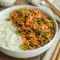 Firecracker Ground Chicken Bowl for Light Family Dinners, served in a colorful skillet with broccoli and a sweet-spicy sauce.