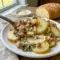 A cozy dinner scene featuring Zuppa Toscana Casserole with melted cheese, potatoes, and sausage for Zuppa Toscana Bake comfort.