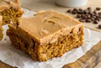 Square of moist coffee walnut cake topped with glossy fudge icing, a perfect Coffee Fudge Traybake cut fresh from the 9x13 pan.