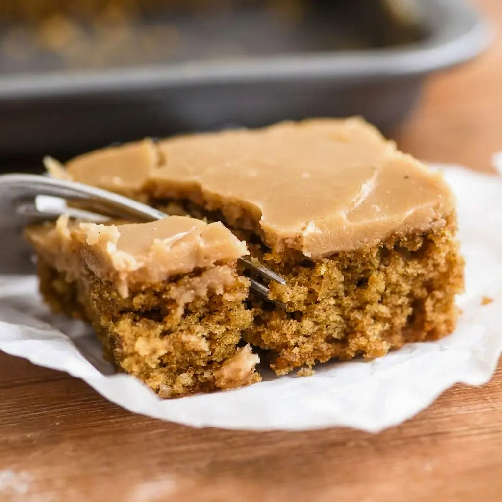 Overhead view of a whole Coffee Fudge Traybake sliced into neat squares, ready to serve at a potluck, party, or coffee break.