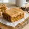 Square of moist coffee walnut cake topped with glossy fudge icing, a perfect Coffee Fudge Traybake cut fresh from the 9x13 pan.